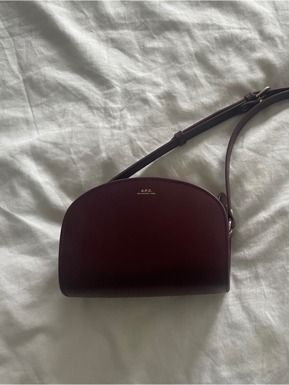 A.P.C. Demi-Lune Crossbody in Deep Burgundy with Gold Logo